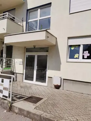 a white house with a door and windows at Apartman Anja in Banja Luka