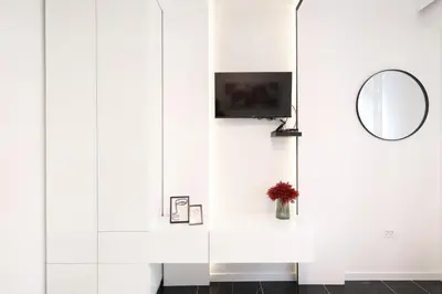 a room with a mirror and a tv on a wall at Central Point Apartmani, Banja Luka in Banja Luka