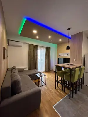 a living room with a couch and a table with chairs at Apartmani Kastel 3 in Banja Luka