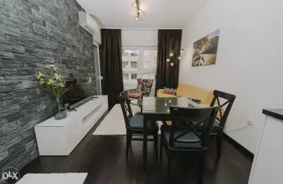 a kitchen and dining room with a table and chairs at Apartmani Kastel 4 in Hiseti