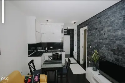 a kitchen and living room with a brick wall at Apartmani Kastel 4 in Hiseti