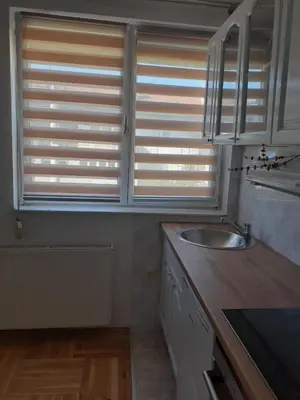 a kitchen with a sink and two windows at Komforni Apartmani Banja Luka in Banja Luka