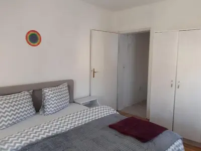 a bedroom with a bed and a closet at Komforni Apartmani Banja Luka in Banja Luka