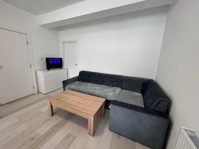 a living room with a couch and a table at Stan na dan GlobusMG in Mrkonjić Grad