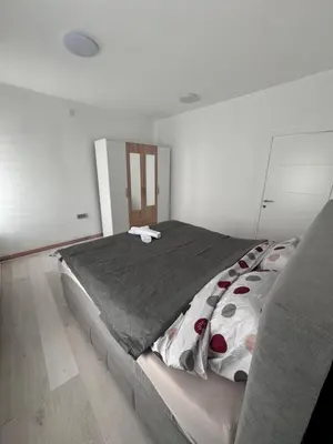 a bedroom with a large bed in a room at Stan na dan GlobusMG in Mrkonjić Grad
