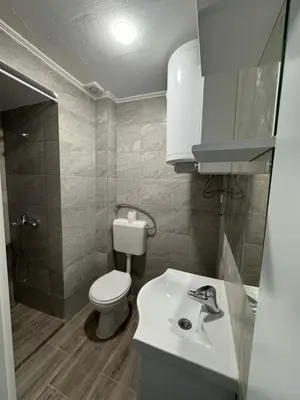 a small bathroom with a toilet and a sink at Stan na dan GlobusMG in Mrkonjić Grad
