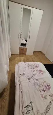 a bedroom with a bed with a blanket on the floor at Stan Banja Luka Paprikovac in Banja Luka