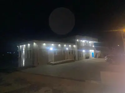 a building with lights on it at night at Stan Banja Luka Paprikovac in Banja Luka