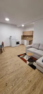 a living room with a couch and a table at Stan Banja Luka Paprikovac in Banja Luka
