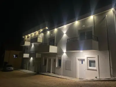 a white building with balconies on it at night at Stan Banja Luka Paprikovac in Banja Luka