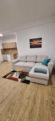 a living room with a white couch and a table at Stan Banja Luka Paprikovac in Banja Luka