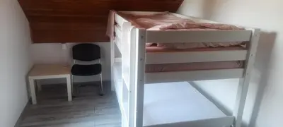 a small bedroom with a bunk bed and a desk at Holiday home Alexa in Banja Luka