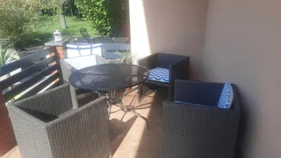a patio with a glass table and chairs on a balcony at Holiday home Alexa in Banja Luka