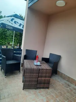 a table and chairs and an umbrella on a patio at Holiday home Alexa in Banja Luka