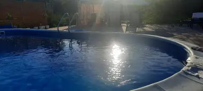 a large pool of water with the sun shining at Holiday home Alexa in Banja Luka