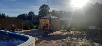 a backyard with a swimming pool and a gazebo at Holiday home Alexa in Banja Luka