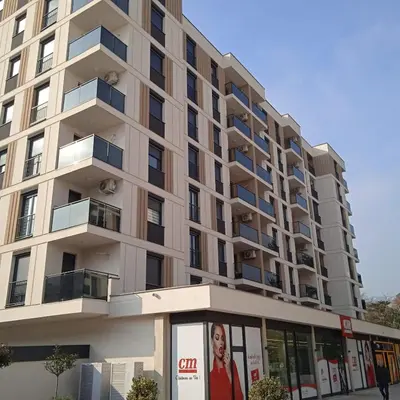a large apartment building with a sign in front of it at Apartman Doboj in Doboj