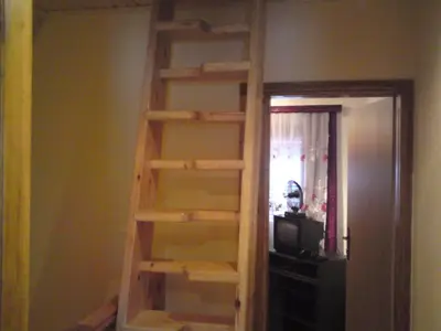 a wooden book shelf in a room with a television at Endzi VS Vlašić in Travnik