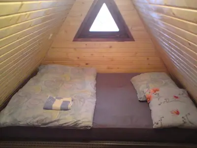 a bed in a room with a window and two pillows at Endzi VS Vlašić in Travnik