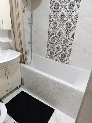 a bathroom with a shower and a bath tub at Apartman Bulevar Živinice in Živinice