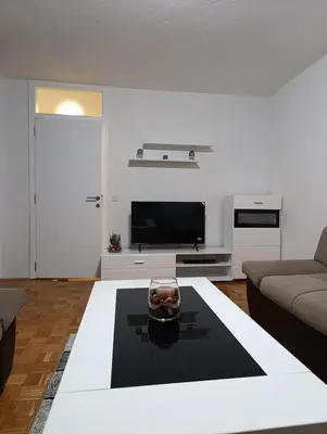 a living room with a couch and a table at Apartman Bulevar Živinice in Živinice