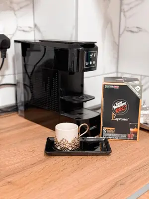 a coffee cup on a tray in front of a microwave at Apartment Saturday in Travnik