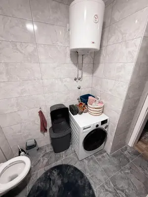 a small bathroom with a sink and a toilet at Apartment Saturday in Travnik