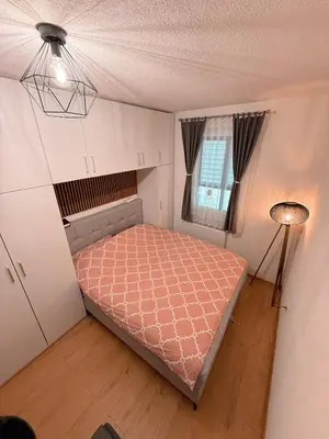 a small bedroom with a bed and a window at Apartment Saturday in Travnik