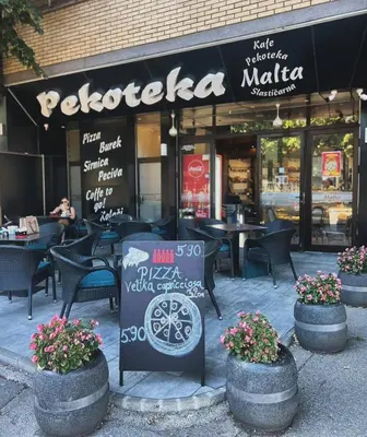 a restaurant with chairs and a sign in front of it at Apartment 27 small in Banja Luka