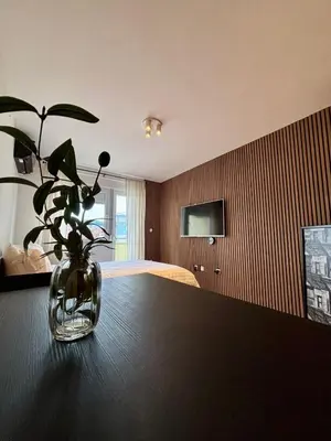 a vase with a plant sitting on top of a table at Apartman MINI in Doboj