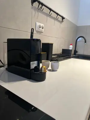 a microwave sitting on a counter in a kitchen at Apartman MINI in Doboj