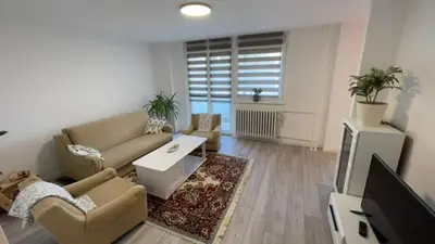 a living room with a couch and a tv at HomeSpot Banja Luka in Banja Luka