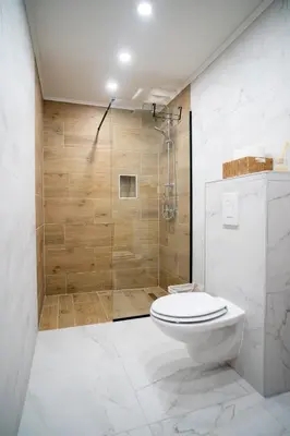 a bathroom with a toilet and a shower at Planinska Kuća OBLAK in Kupres