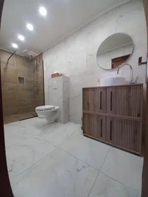 a bathroom with a toilet and a sink and a shower at Planinska Kuća OBLAK in Kupres