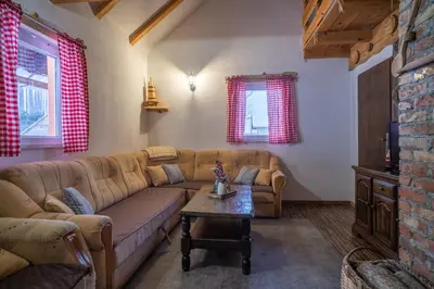 a living room with a couch and a table at Planinska Kuća OBLAK in Kupres