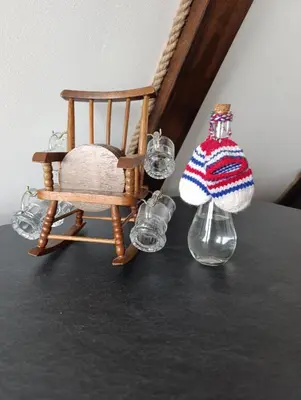 a table with a chair and glasses and a hat at Mountain house Tomislavgrad in Tomislavgrad