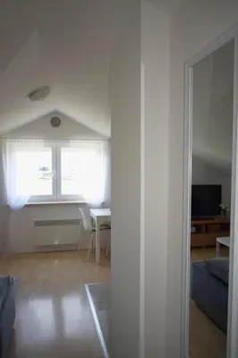 a living room with a window and a table at Apartman Panorama in Tomislavgrad