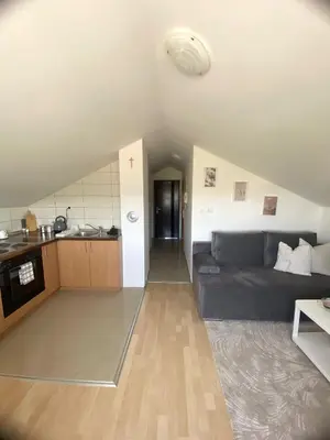 a living room with a couch and a kitchen at Apartman Panorama in Tomislavgrad