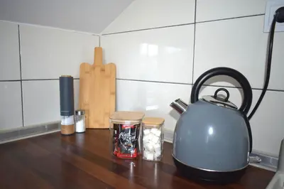 a tea kettle on a kitchen counter with spices at Apartman Panorama in Tomislavgrad