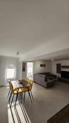 a living room with a table and a couch at Apartman Milica in Banja Luka
