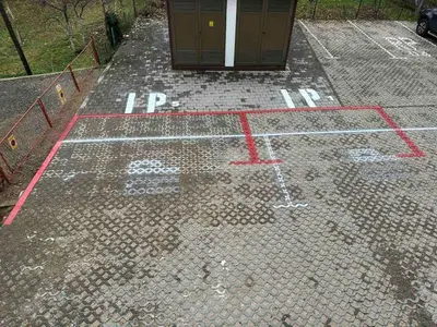 a parking lot with red paint on the ground at Apartman Milica in Banja Luka