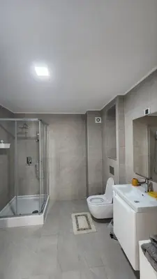 a bathroom with a shower and a toilet and a sink at Apartman Milica in Banja Luka