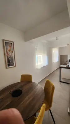 a dining room with a wooden table and chairs at Apartman Milica in Banja Luka