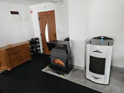 a living room with a stove in a room at Vikendica Bilanović in Donji Vakuf