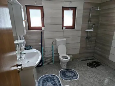 a bathroom with a toilet and a sink and a shower at Vikendica Bilanović in Donji Vakuf