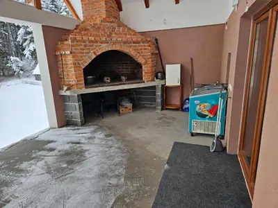 a living room with a brick fireplace in a house at Vikendica Bilanović in Donji Vakuf