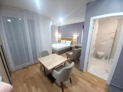 a small room with a table and a bathroom at MN apartman in Banja Luka