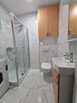 a bathroom with a shower and a toilet and a sink at Apartmani Stan na dan 34 in Banja Luka