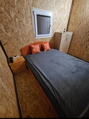 a small bed in a room with a window at blanca 6 in Nova Bila