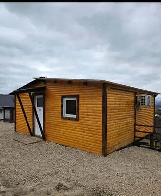 a large wooden cabin with a small window at blanca 6 in Nova Bila